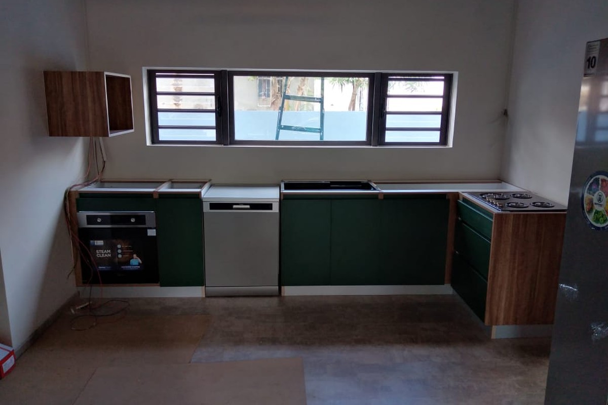 Green kitchen with integrated appliances
