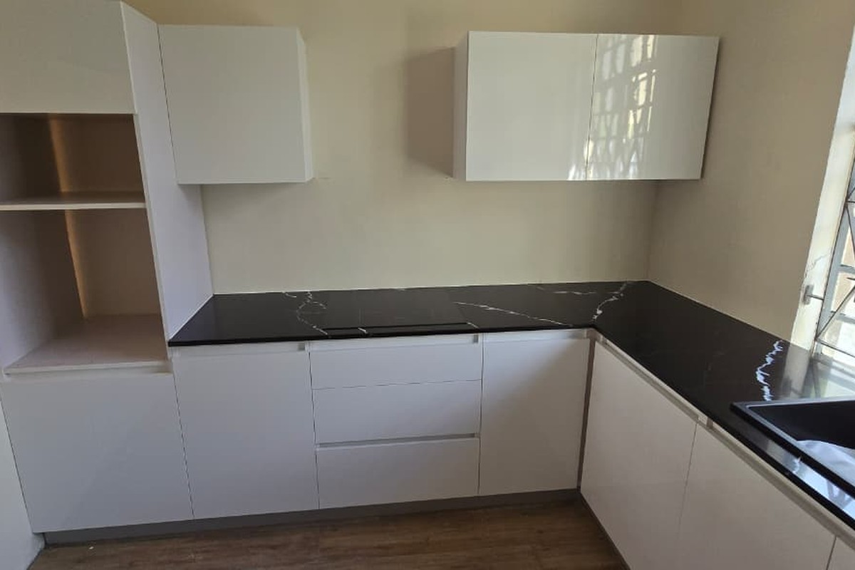White kitchen with dark granite countertop
